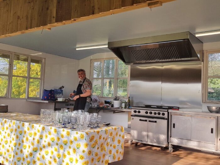The chef in the field kitchen at Greenacre Events, Devon